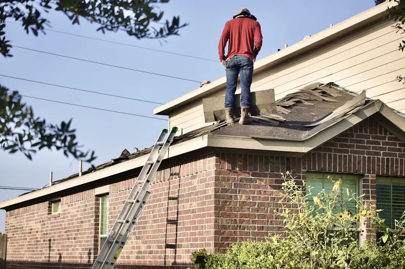 Professional roofer working on a residential roof in Belmont Heights